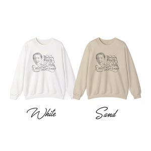 May include: Two sweatshirts, one white and one sand-colored, with a graphic design. The design features a vintage-style image of a person's face and the words "Dirty Mouth" and "Why you calling together you lint licker?"