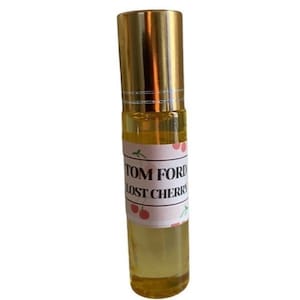 May include: A gold roller bottle with a white label that says "TOM FORD LOST CHERRY" and has a cherry design.