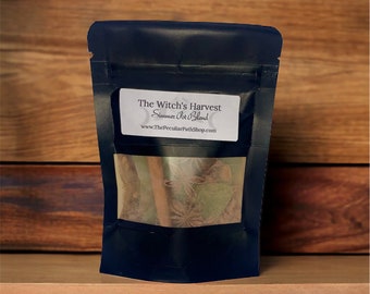 May include: A black resealable pouch with a clear window showing a blend of dried herbs and spices. The pouch has a white label that reads "The Witch's Harvest Summer Pot Blend" and a website address.