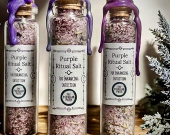 May include: Three small glass bottles filled with purple ritual salt. Each bottle is sealed with a purple wax top and has a label that reads "Purple Ritual Salt for Enhancing Intuition The Peculiar Path".