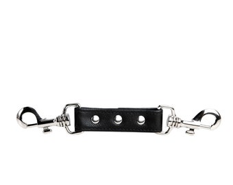 May include: A black leather strap with two silver metal clips and three holes. The strap is about 2 inches long.