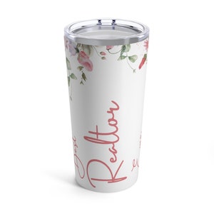 May include: White stainless steel tumbler with a floral design and the name "Kendall" in pink lettering.