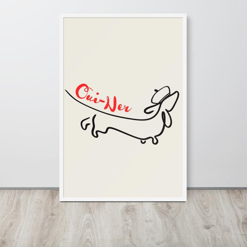 May include: Framed art print featuring a minimalist line drawing of a dachshund wearing a beret. The word "Oui-Ner" is written in red cursive above the dog. The artwork is set against a cream background within a white frame.
