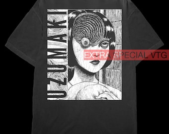 May include: Black t-shirt with a white graphic print of a woman with a spiral pattern over her eye. The text "UZUMAKI" is printed on the left side of the graphic. The text "EXTRA SPECIAL VTG" is printed in white on a red background at the bottom right corner of the graphic.
