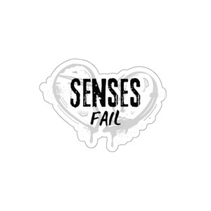 May include: A white heart-shaped sticker with a black grunge-style design. The text "SENSES FAIL" is printed in black.