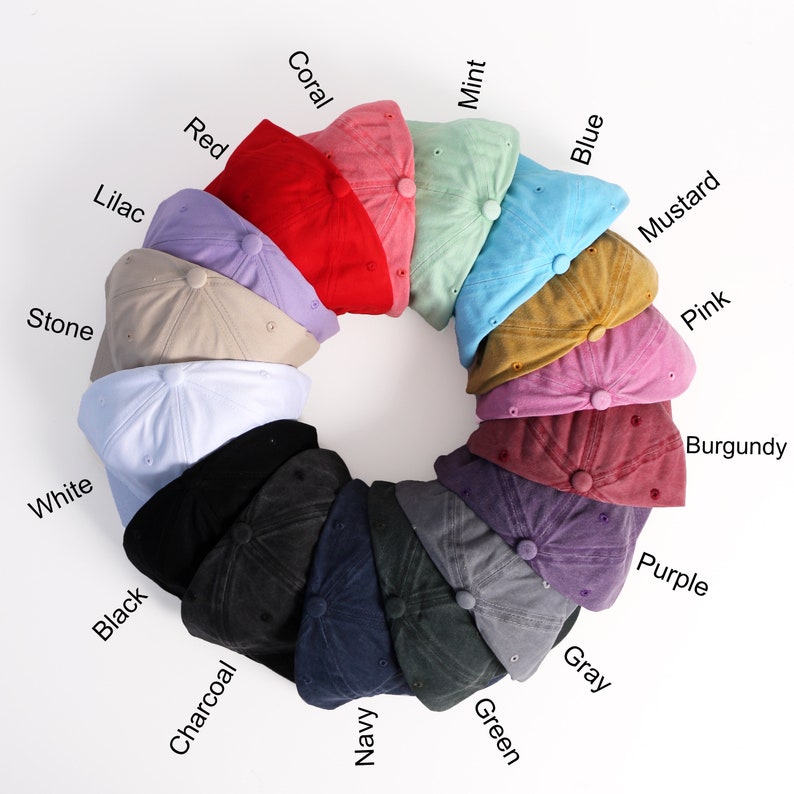May include: A circle of 15 baseball caps in various colors, including white, black, charcoal, navy, green, gray, purple, burgundy, pink, mustard, blue, mint, coral, red, and lilac.