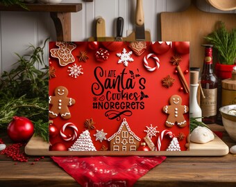 May include: A festive red sign with the text "I ate Santa's Cookies #NoRegrets" surrounded by gingerbread men, snowflakes, and candy canes. The sign is displayed on a wooden surface with Christmas decorations.