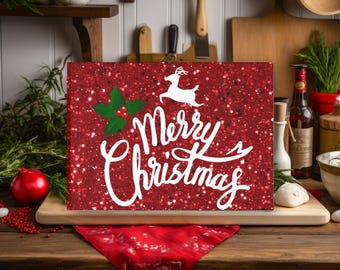 May include: A rectangular Christmas sign with a red glitter background and white text that reads "Merry Christmas." A white reindeer and holly with berries are also featured. The sign is displayed on a wooden surface.
