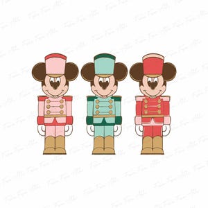 May include: Three cartoon-style nutcracker figures featuring Mickey Mouse heads. Each figure wears a different colored uniform: pink, teal, and red. The uniforms have gold buttons and trim, with tan boots and hats.