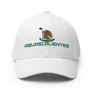 May include: White baseball cap with an embroidered green and gold Mexican eagle holding a golf club and the text "AGUASCALIENTES" in green.
