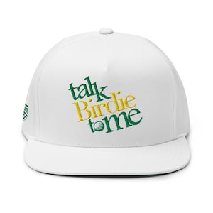 May include: White flat-brimmed baseball cap with the embroidered text "Talk Birdie to Me" in green and yellow. The cap has a structured fit and a flat brim. The hat is a golf-themed accessory.