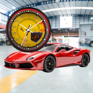 May include: A red sports car is parked in front of a yellow and black clock. The clock has a yellow face with black numbers and a horse logo. The clock also has the text "RPM x 1000" and "P auto".