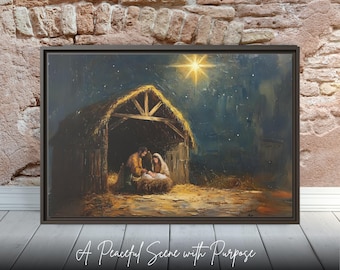 May include: Framed artwork depicting a nativity scene with Mary, Joseph, and baby Jesus in a stable under a starry night sky. The artwork is framed in a dark brown frame and rests on a white wooden surface. The text "A Peaceful Scene with Purpose" is at the bottom.