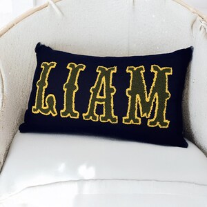 Bohemian home decor accent pillow with punch needle embroidered Liam lettering, ideal for new home styling or thoughtful new mom gifts.