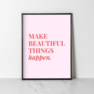 May include: A framed print with a pink background and the text "MAKE BEAUTIFUL THINGS happen." in red.