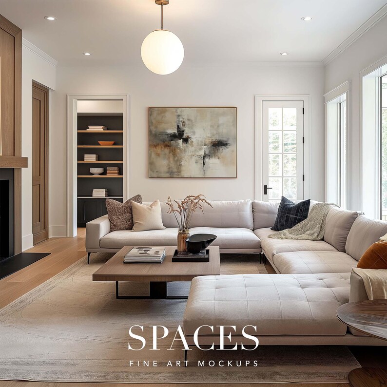 May include: A white sectional sofa with a wooden coffee table in a modern living room. The room features a large abstract painting on the wall, a wooden door, and a bookshelf.