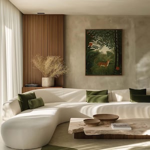 May include: A white curved sofa with green throw pillows sits in a living room with a wooden wall and a framed print of a tiger in a jungle. A wooden coffee table with a natural edge sits in front of the sofa.