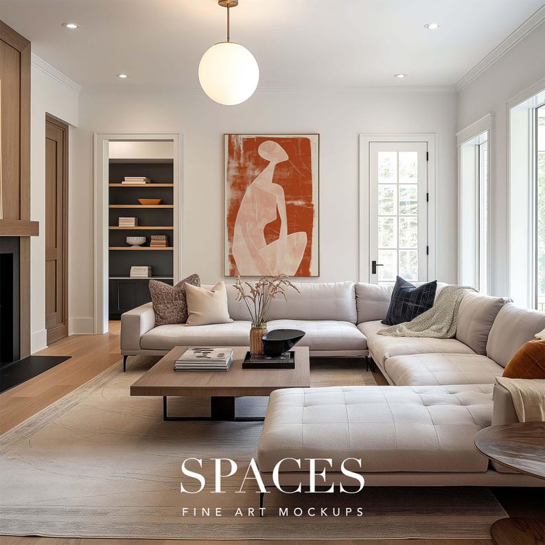 May include: A white sectional sofa with a light gray throw blanket and a dark gray pillow. The sofa is in a living room with a large abstract painting of a person in a red and white color scheme. The room has a wooden floor and a large window.