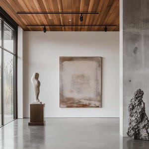 May include: An interior shot of a modern art gallery with a polished concrete floor and a wooden ceiling. The gallery features a large abstract painting, a white sculpture on a pedestal, and a dark, textured sculpture.