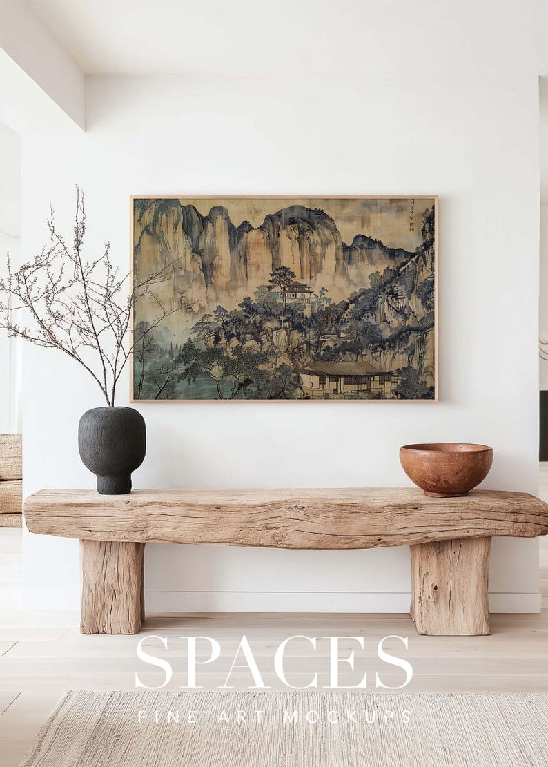 Puede incluir: Un banco de madera r&uacute;stico con un acabado natural se coloca en una habitaci&oacute;n minimalista con paredes blancas. Un jarr&oacute;n negro con un arreglo de ramas secas y un taz&oacute;n marr&oacute;n est&aacute;n en el banco. Una pintura enmarcada de un paisaje de monta&ntilde;a cuelga en la pared sobre el banco.