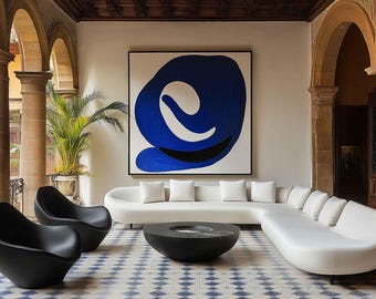 May include: An outdoor living space featuring a modern white sofa, two black chairs, and a black coffee table. A large abstract blue and white painting hangs on the wall. The floor has a blue and white tile pattern.