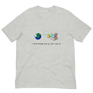 May include: A gray t-shirt with a graphic of a computer, a phone, and a globe with the text "I lived through dial-up, don't test me".