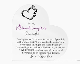 May include: A white heart-shaped plaque with a black silhouette of a heart and butterflies. The plaque has a message for a granddaughter, "To My Granddaughter Samantha. I can't promise I'll be here for the rest of your life, but I promise that I'll love you for the rest of mine. I've hugged this tight, and filled it with my love and light so my love will shine on you always. NEVER FORGET how how special you are and never give up on chasing your dreams. Love, Grandma."