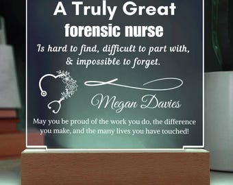 May include: A lighted acrylic plaque with the text "A Truly Great forensic nurse" and a message. The plaque has a wooden base and a heart-shaped stethoscope design. The name "Megan Davies" is also displayed.