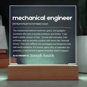 May include: A light-up sign featuring the words "mechanical engineer" in white, with a definition below. The sign is set on a wooden base. The text also includes "ALSO KNOWN AS: Joseph Smith."