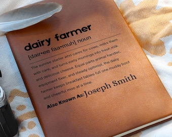 May include: A brown leather-bound notebook with the words "dairy farmer" in bold black letters. The definition of "dairy farmer" is printed below, along with the name "Joseph Smith". A feather rests on the top left corner.