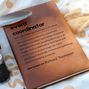 May include: A brown leather-bound journal with the word "event coordinator" defined as "The celebration conductor, armed with checklists, timelines, and a sense of humor that can turn event planning into a party of laughs." The journal also states "Also Known As: Richard Thompson".