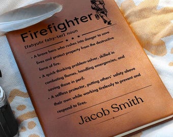 Può includere: Un diario in pelle marrone con la definizione della parola "Vigile del fuoco" e un'illustrazione di un vigile del fuoco. Il nome "Jacob Smith" è inciso in basso.