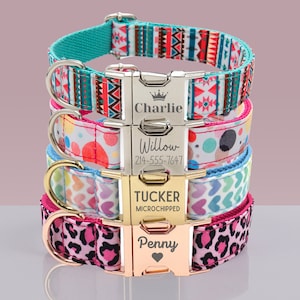 May include: A stack of personalized dog collars in various patterns and colors. The top collar has a turquoise base with a geometric design. The second collar has a white base with colorful polka dots. The third collar has a light blue base with heart shapes. The bottom collar has a pink leopard print.