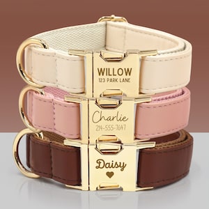 May include: Three personalized dog collars in cream, pink, and brown leather. Each collar features a gold-colored buckle engraved with a name and contact information. The collars are stacked, showcasing the different colors and designs.