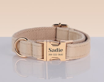 May include: Beige canvas dog collar with a rose gold buckle and a personalized name tag that reads "Sadie" and a phone number.