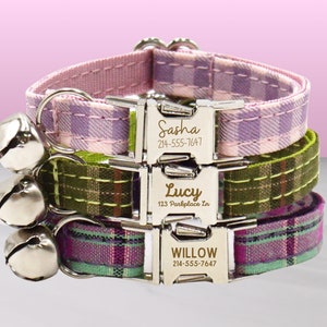 May include: Three personalised dog collars with silver buckles and bells. The collars are pink and white plaid, green and brown plaid, and purple and green plaid. The collars are engraved with the names Sasha, Lucy, and Willow, along with phone numbers.