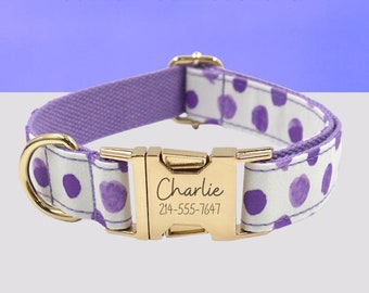 May include: Purple and white dog collar with a gold buckle. The buckle is engraved with the name "Charlie" and the phone number "214-555-7647".