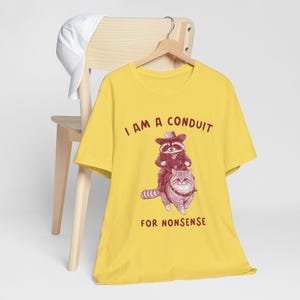 Funny Raccoon Cowboy Riding Cat T-Shirt, I Am a Conduit for Nonsense Shirt, Quirky Graphic Tee, Retro Animal Humor Shirt, Cowboy Cat Tee image 3