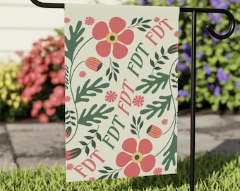 May include: A cream-colored garden flag with a repeating pattern of red flowers, green leaves, and the text "FDT FDT FDT FDT FDT".