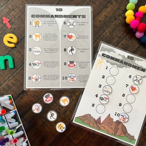 May include: A set of 10 Commandments learning materials, including a printable sheet with the text of the Commandments and a separate sheet with circles for placing tokens. The tokens feature images representing each Commandment. The set also includes a set of colorful magnetic letters spelling out the word "ten".