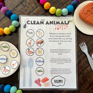 May include: A printable educational chart with the title "Clean Animals" and a list of animals that are considered clean to eat. The chart includes a quote about animals that divide a hoof and chew the cud. The chart also includes a quote about animals that live in the water and have fins and scales. The chart also includes a quote about winged insects that walk on all fours. The chart includes a picture of a plate with a variety of food items, including a steak, salmon, and eggs. The chart also includes a picture of a fork and a knife.