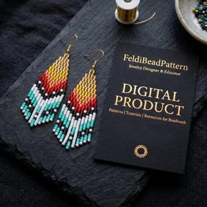 May include: A pair of beaded fringe earrings featuring a gradient pattern of yellow, orange, red, black, white, and turquoise beads. Next to the earrings is a black card with gold text reading FeldiBeadPattern Jewelry Designer & Educator.