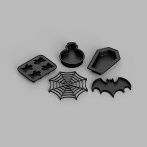 May include: A set of five black plastic molds featuring various shapes including a rectangular tray with four ghost silhouettes, a round potion bottle, a coffin, a spider web, and a bat. These items are designed for crafting or baking purposes.