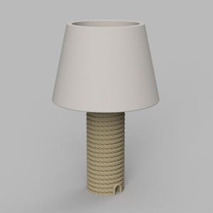 May include: A beige table lamp with a cylindrical base wrapped in natural rope. The lampshade is a light beige, conical shape. The lamp is a neutral color and would fit in many home decor styles.