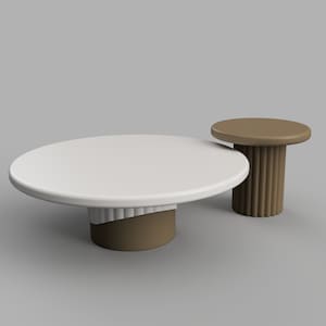 May include: Two round tables with white tops and brown bases. The larger table has a wavy, fluted base. The smaller table has a smooth, cylindrical base.