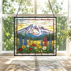 May include: A rectangular stained glass panel featuring a snow-capped mountain peak above a field of colorful wildflowers including blue, yellow, red, and white blossoms. The piece is framed in black metal and hangs from a black chain.