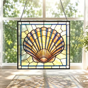 May include: A square stained glass panel featuring a central scallop shell design in shades of amber and gold with blue accents. The piece is framed in black metal and suspended by a black chain, showcasing a geometric grid pattern in the background.