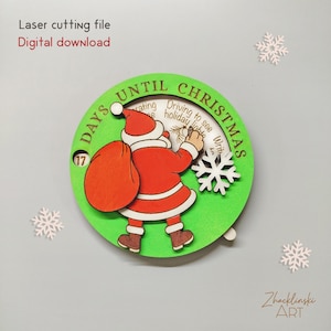 Può includere: Un orologio natalizio in legno con un telaio circolare verde. L'orologio presenta una figura di Babbo Natale con un abito rosso e un grande sacco. Il testo "DAYS UNTIL CHRISTMAS" è visibile. Il testo "Laser cutting file" e "Digital download" è visibile.