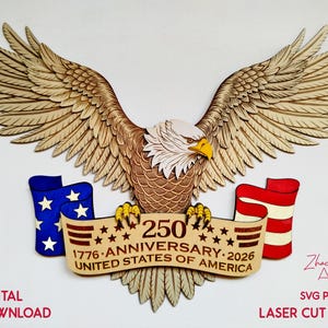May include: A multi-layered wooden wall art piece featuring a bald eagle with wings spread wide, clutching a banner that reads 250 ANNIVERSARY 1776-2026 UNITED STATES OF AMERICA. The design includes blue and red flag accents and laser-cut details.