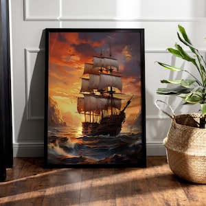 May include: A framed painting of a ship sailing on the ocean at sunset. The ship has white sails and is silhouetted against a fiery orange sky. The painting is in a black frame and is hanging on a white wall.